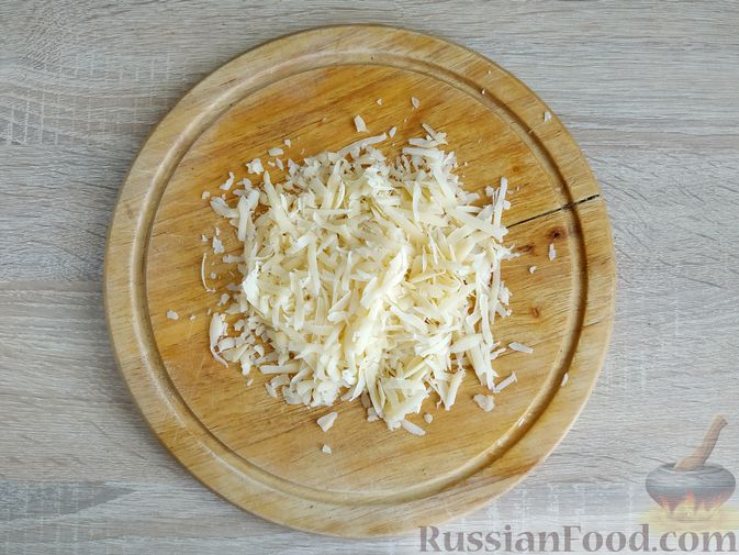 Фото приготовления рецепта: Кабачки, запечённые с помидорами, под сметанным соусом и сыром - шаг №12