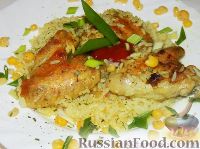 Фото к рецепту: Куриные крылышки с рисом, запеченные в духовке