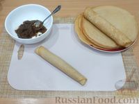 Фото приготовления рецепта: Рулетики из блинов с начинкой из творога и изюма - шаг №19